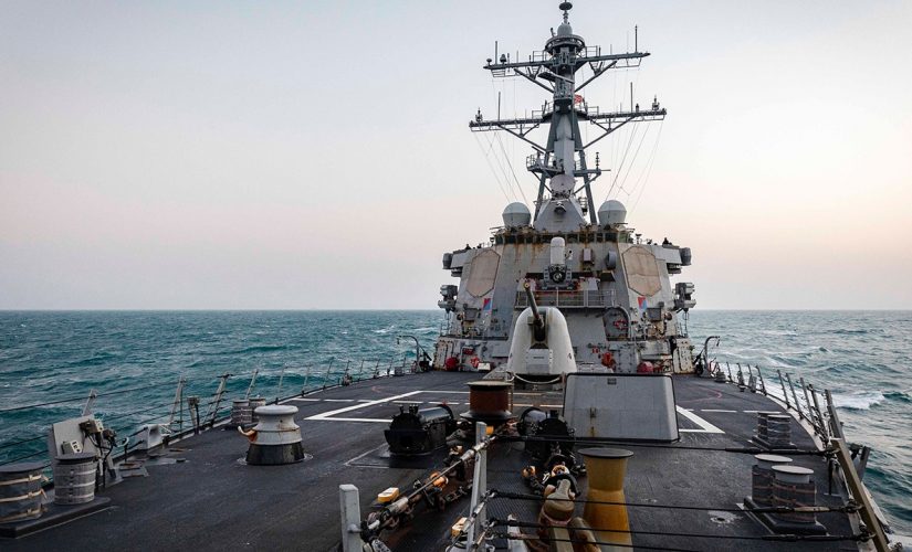 US destroyer sails by disputed islands, shadowed by Chinese warships