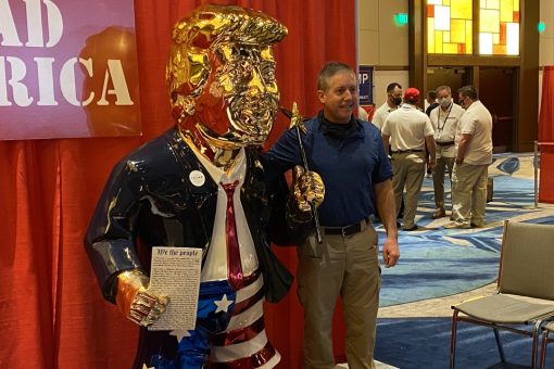 Gold-colored Trump statue at CPAC draws crowd