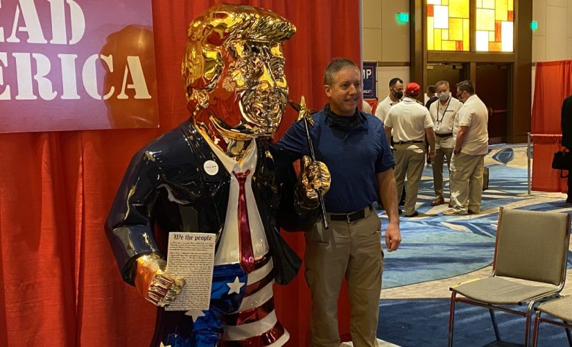Gold-colored Trump statue at CPAC draws crowd
