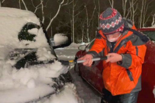 Family friends clear snow from Rhode Island hospital staff’s cars in the midst of winter storm