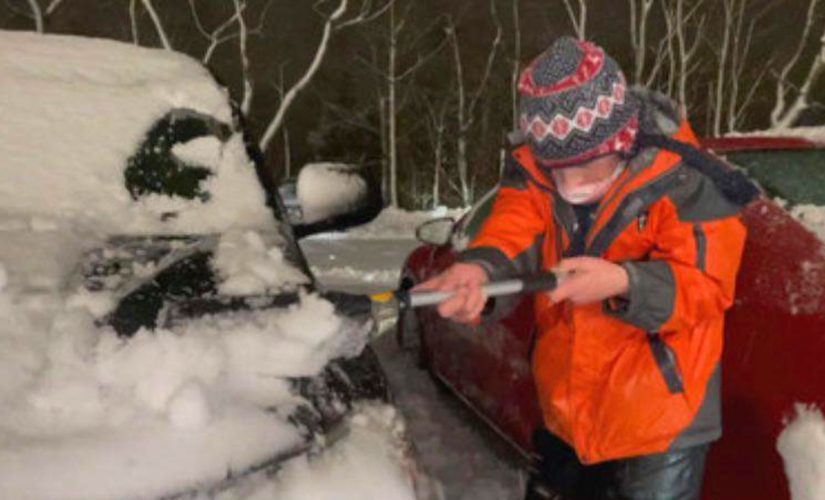 Family friends clear snow from Rhode Island hospital staff’s cars in the midst of winter storm