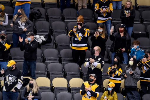 Penguins under fire for photoshopping masks on to fans in social media photo