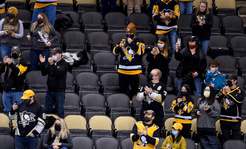 Penguins under fire for photoshopping masks on to fans in social media photo