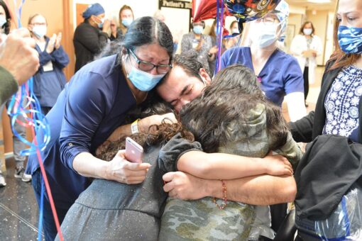 Coronavirus survivor hugs daughters after months-long hospital stay