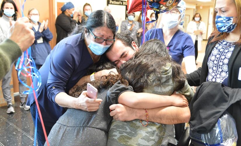 Coronavirus survivor hugs daughters after months-long hospital stay