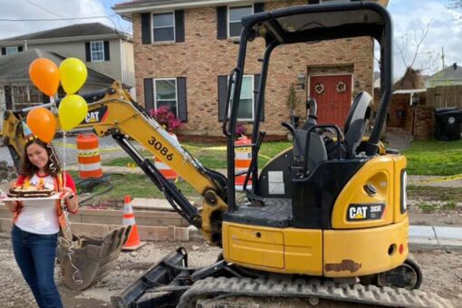 Woman celebrates year of unfinished construction in front of New Orleans home