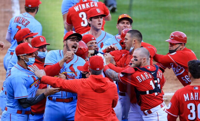 Reds scrap with Cards at plate, tangle in outfield, win 9-6