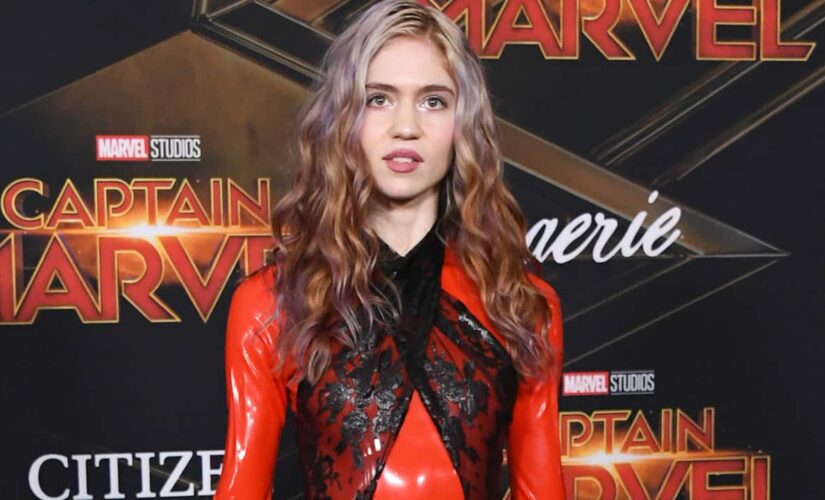 Grimes shares back tattoo of ‘beautiful alien scars’