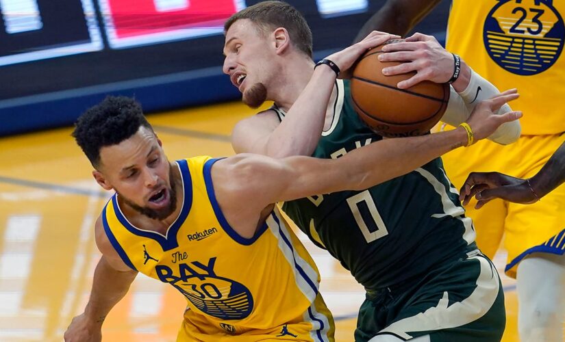 Curry, Warriors use furious finish to hold off Bucks 122-121