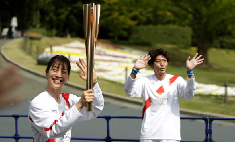Olympic torch runs through empty park in Osaka as cases rise