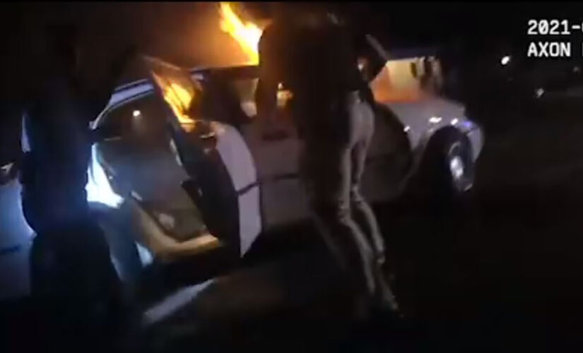 Georgia police save unconscious woman trapped in burning car, video shows