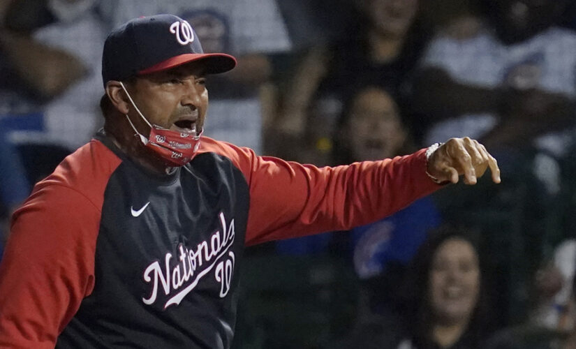 Nationals’ Dave Martinez throws first base after getting ejected from game