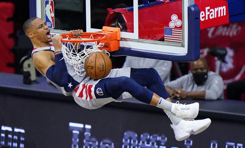 Wizards’ Russell Westbrook has popcorn dumped on him as he walks to locker room