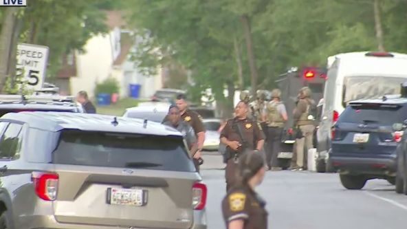 Maryland officers shot while serving arrest warrant, suspect barricaded in home
