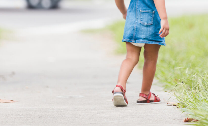 Internet baffled by photo of girl seemingly stuck in sidewalk