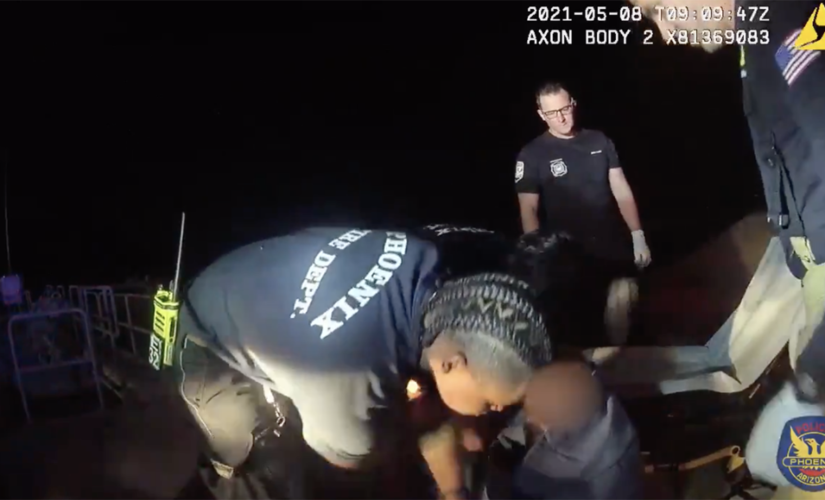 Arizona police officers save man from drowning after his wheelchair tips over into canal, video shows