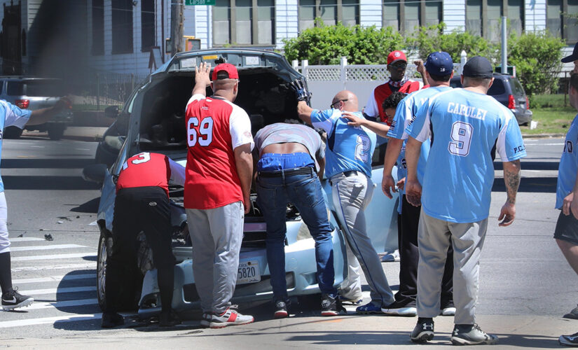 NYPD officers pause softball game to help woman who got in a car crash