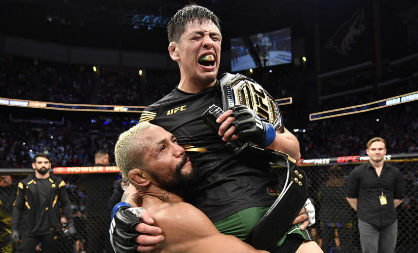 UFC’s Brandon Moreno celebrates with opponent Deiveson Figueiredo after flyweight title victory