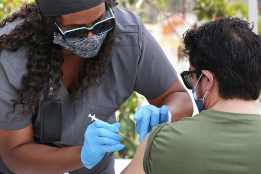 US hits encouraging milestones on virus deaths and shots
