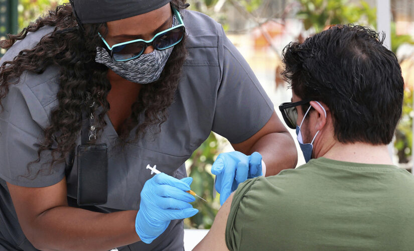 US hits encouraging milestones on virus deaths and shots