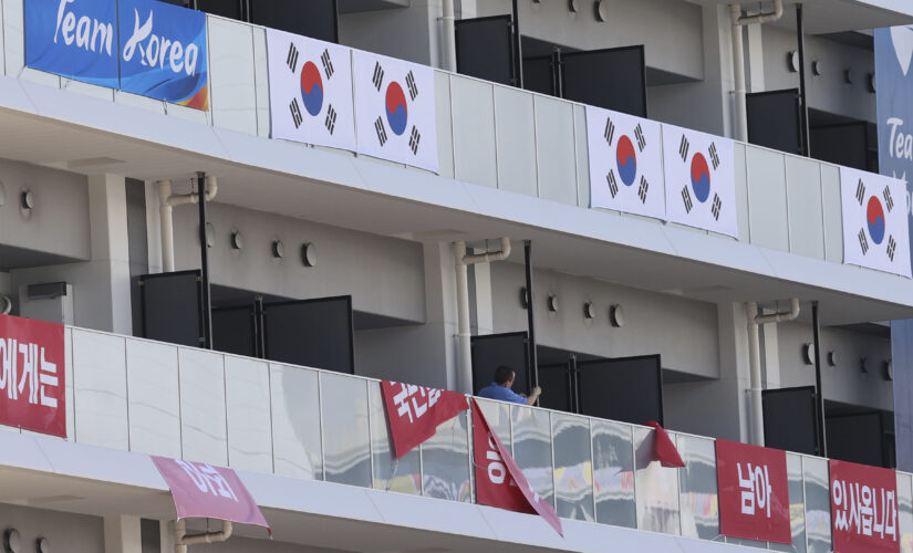 South Korea removes banners at Olympic village after IOC ruling