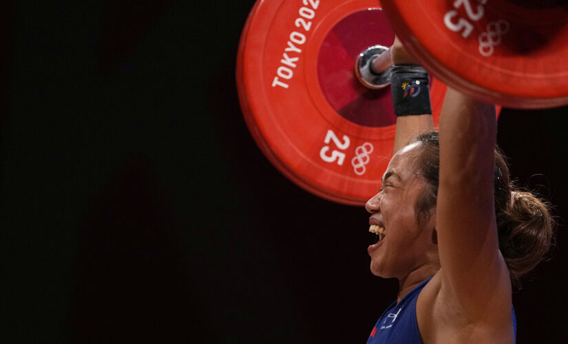 Hidilyn Diaz, Philippines’ first Olympic gold medalist, salutes flag during country’s national anthem