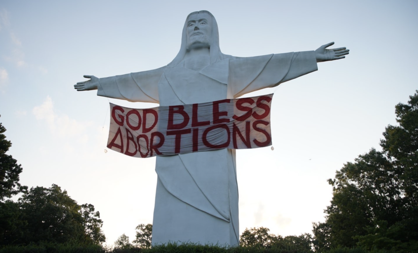 ‘GOD BLESS ABORTIONS’ banner hung on Christ of the Ozarks statue in Arkansas by activist art group