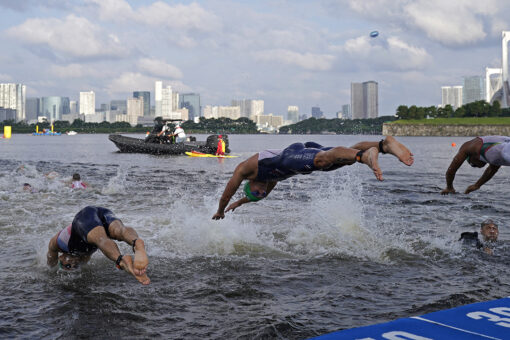 Olympics triathlon briefly delayed after boat moves into athletes’ way in bizarre scene