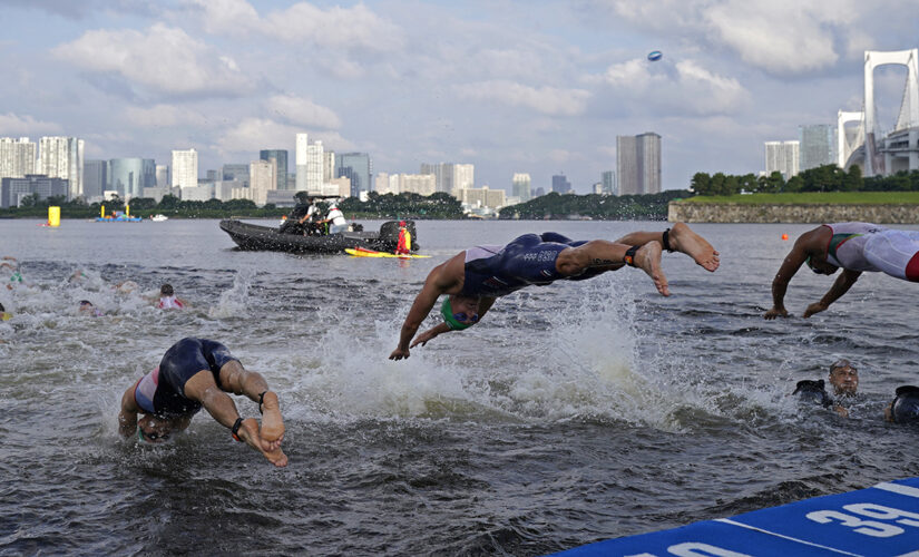 Olympics triathlon briefly delayed after boat moves into athletes’ way in bizarre scene