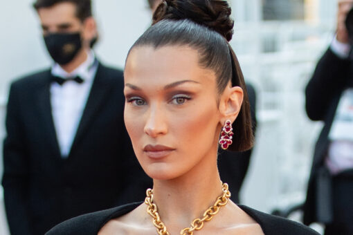 Bella Hadid covers breasts with golden lungs necklace at Cannes