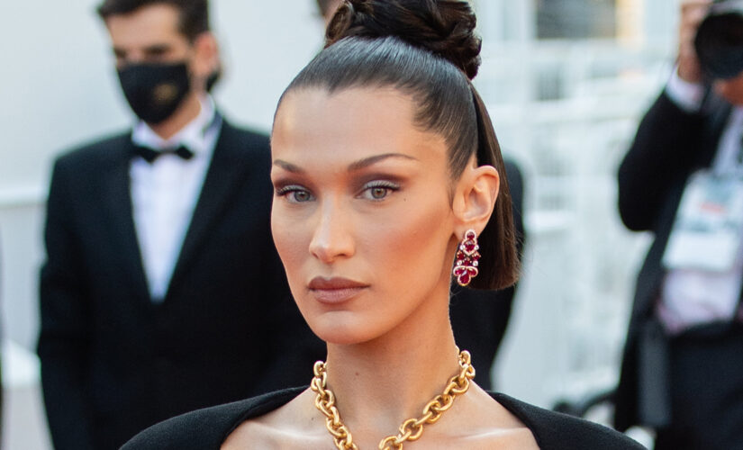 Bella Hadid covers breasts with golden lungs necklace at Cannes