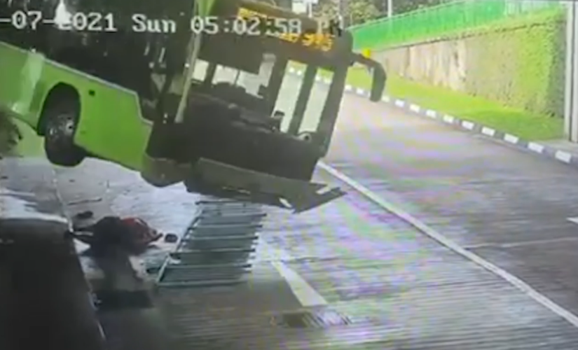 Driver narrowly escapes being crushed by falling bus