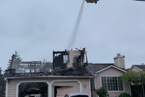 Washington man barricaded in burning building, shot at officers: police