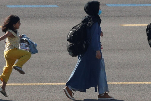 Afghan girl seen in viral photo skipping on airport tarmac after arriving in Brussels following evacuation