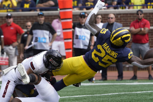 Corum’s 3 TDs help No. 25 Michigan rout N. Illinois 63-10