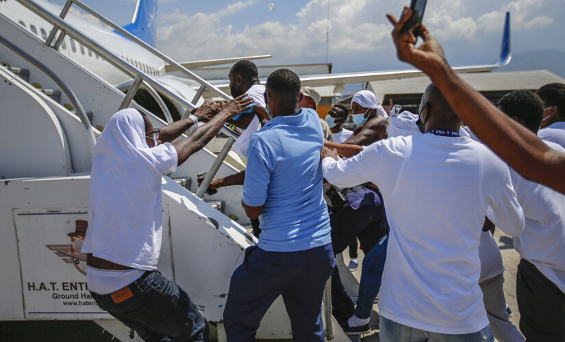 Expelled Haitian migrants try to get back on plane returning to US