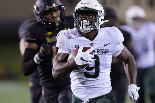 Walker runs for 264 yards as Spartans beat Wildcats 38-21
