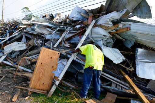 Ida-battered New Orleans cleans up trash as streets begin to stink