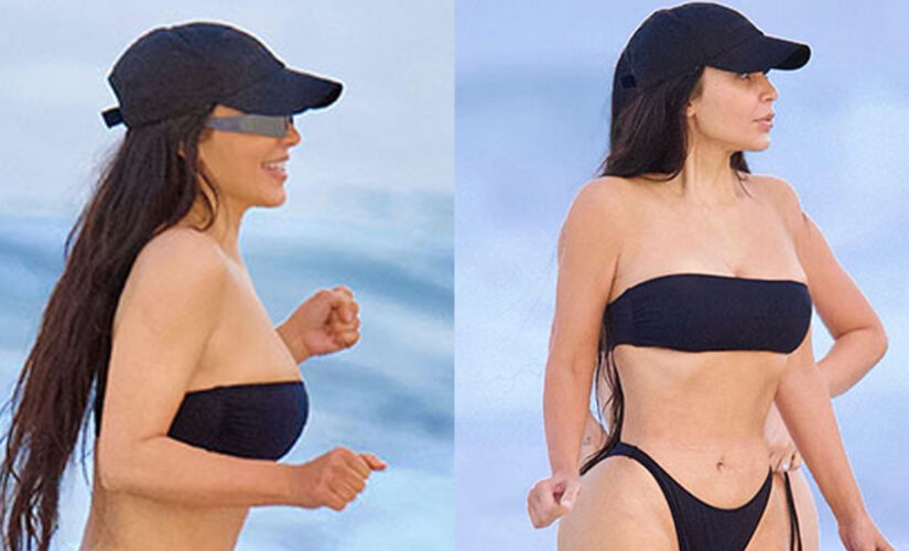 Kim Kardashian flaunts figure in cheeky black bikini during beach outing