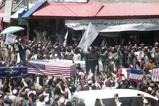 Taliban supporters hold mock funerals for with coffins draped with American flags
