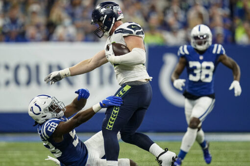 Seahawks’ Will Dissly with an abusive stiff arm