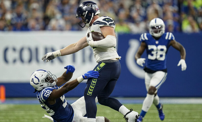 Seahawks’ Will Dissly with an abusive stiff arm