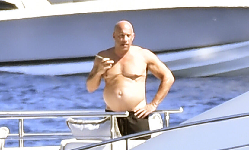 Shirtless Vin Diesel suns himself on luxury yacht in Italy