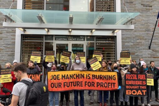 Climate group protests outside of where Manchin docks his houseboat