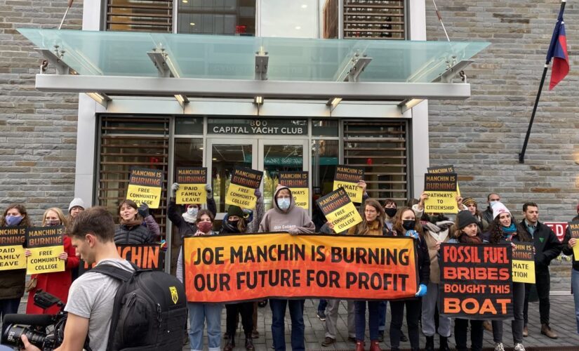 Climate group protests outside of where Manchin docks his houseboat