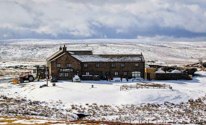 Snowplow clears path for dozens stranded inside England pub