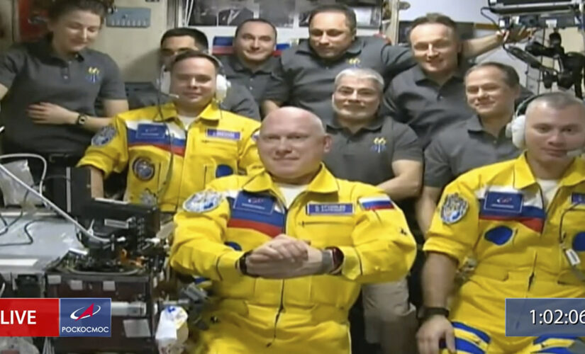 Russian cosmonauts wear Ukrainian colors in arrival at International Space Station