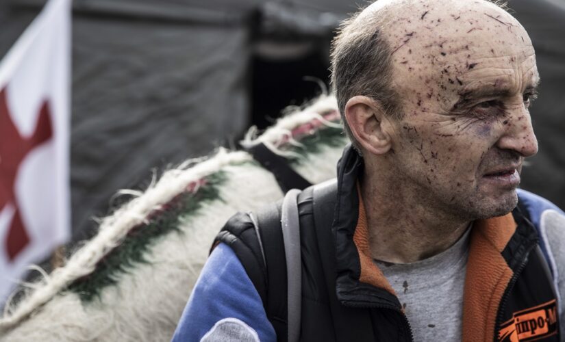 Russia-Ukraine war: Photos show Ukrainians traversing broken bridges to flee as those at home bury their dead