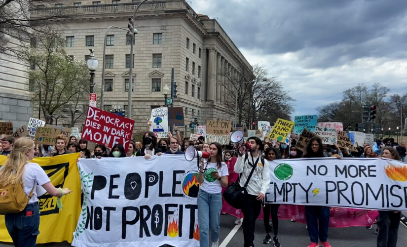 Activists march through DC demanding Biden declare a climate emergency