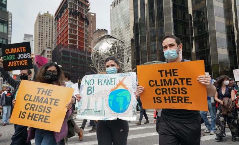 NYC climate protesters block intersection, climb on top of subway station